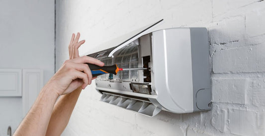  AC REPAIRMAN TAKING OFF FILTER FROM AC